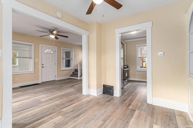 entryway featuring light hardwood / wood-style floors, ceiling fan, and a wealth of natural light