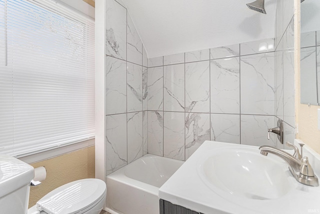 full bathroom with toilet, vanity, and tiled shower / bath