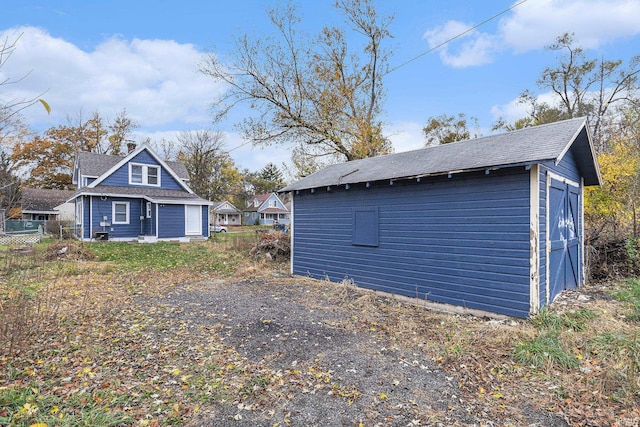 view of property exterior with an outbuilding