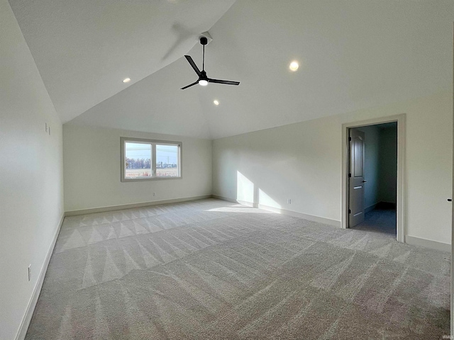 spare room featuring high vaulted ceiling, light colored carpet, and ceiling fan