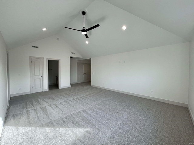 unfurnished bedroom featuring vaulted ceiling, light carpet, and ceiling fan