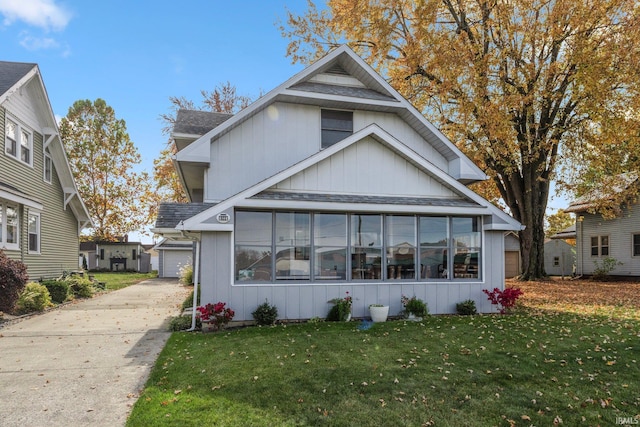 exterior space with a lawn and a sunroom