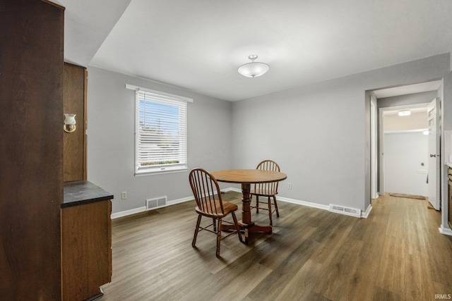 dining room with dark hardwood / wood-style flooring