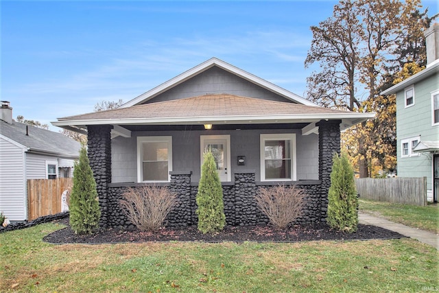 bungalow-style home with a porch and a front yard