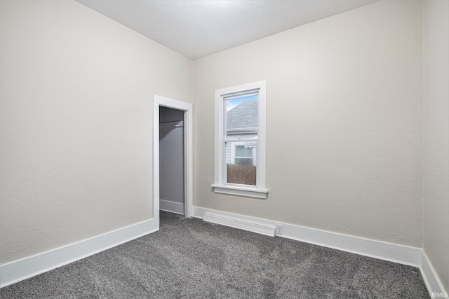 empty room with dark carpet