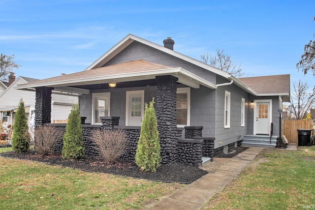 view of front of house featuring a front lawn and covered porch