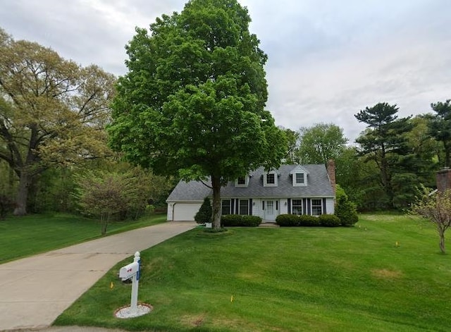 view of front of property with a front yard and a garage