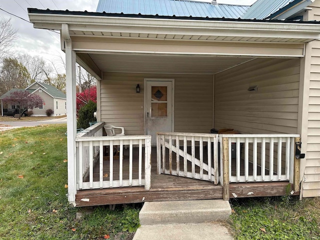 view of exterior entry featuring a yard