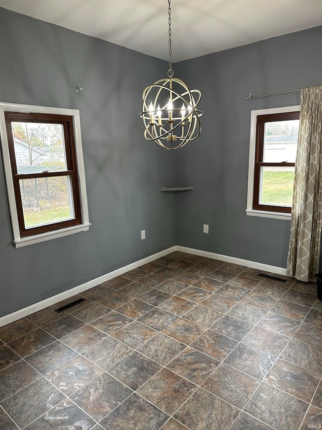 interior space featuring plenty of natural light and a notable chandelier