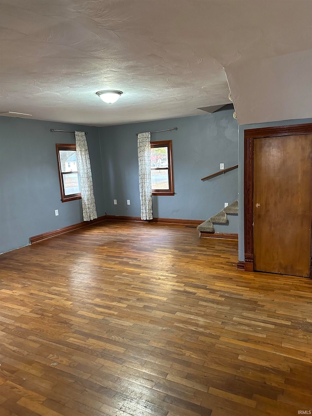 empty room with hardwood / wood-style floors and a wealth of natural light