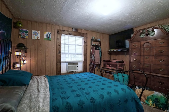 bedroom with wood walls, a textured ceiling, cooling unit, and carpet