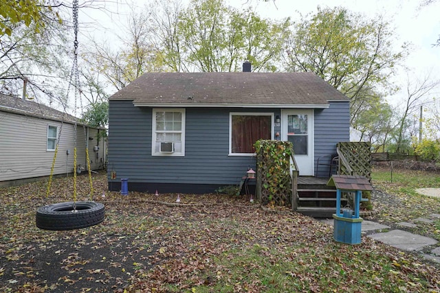 rear view of property featuring an outdoor fire pit