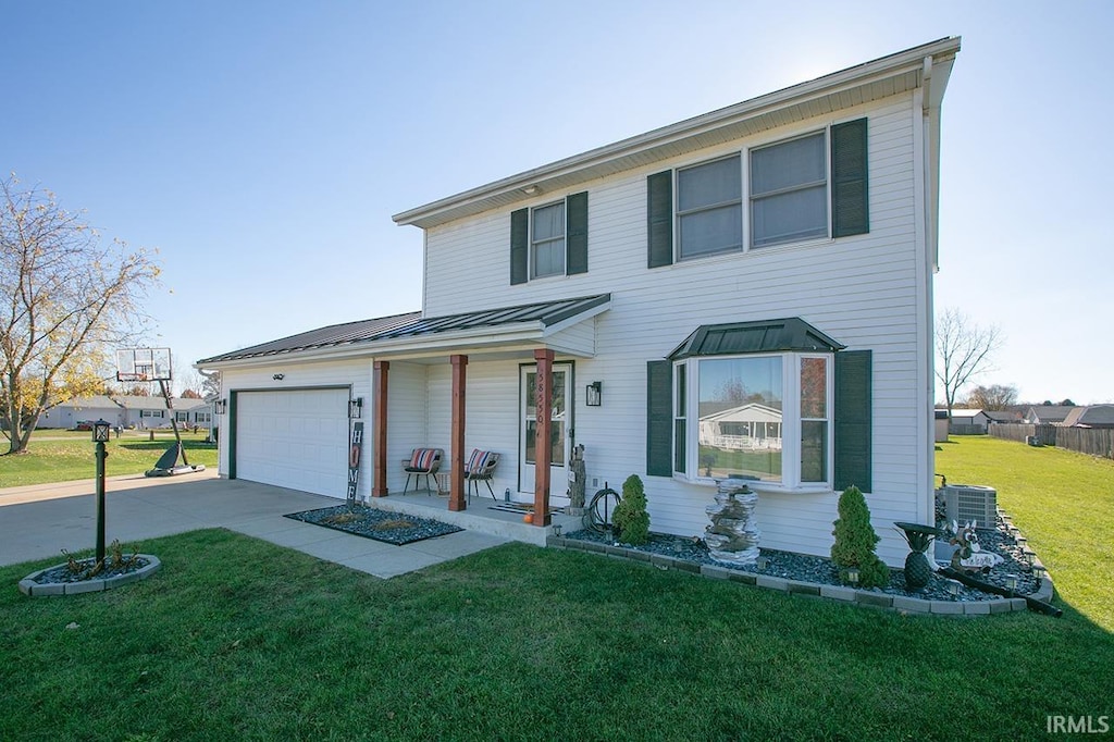 view of front of house with a garage and a front lawn