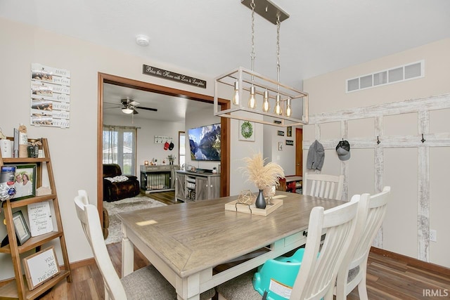 dining area with ceiling fan and wood-type flooring