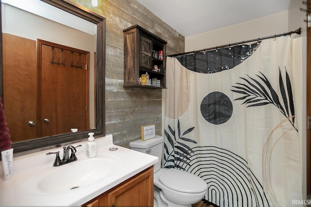 bathroom with tile walls, vanity, toilet, and backsplash