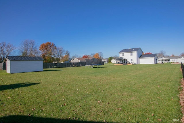 view of yard with a shed and a trampoline