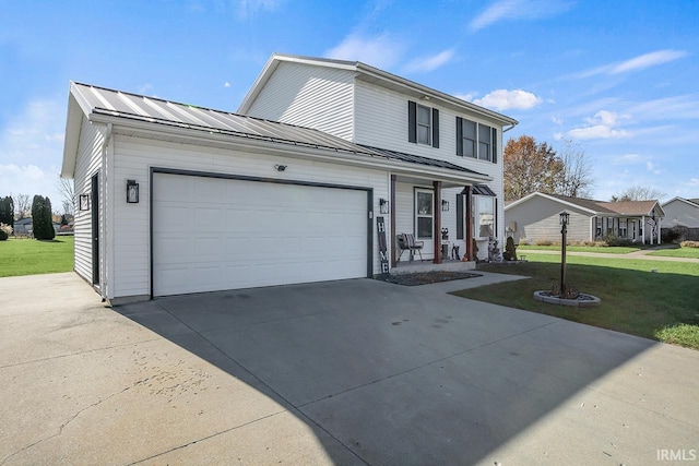 view of front of property featuring a garage and a front lawn