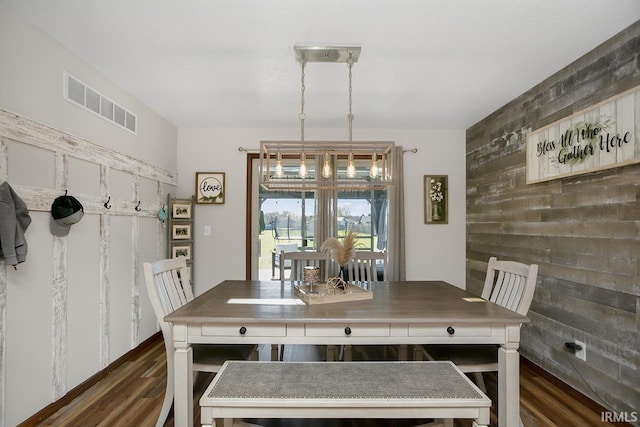 dining area featuring an inviting chandelier and dark hardwood / wood-style flooring