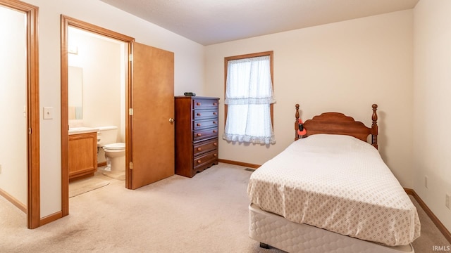 carpeted bedroom with ensuite bathroom