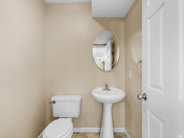 bathroom with toilet and tile patterned floors