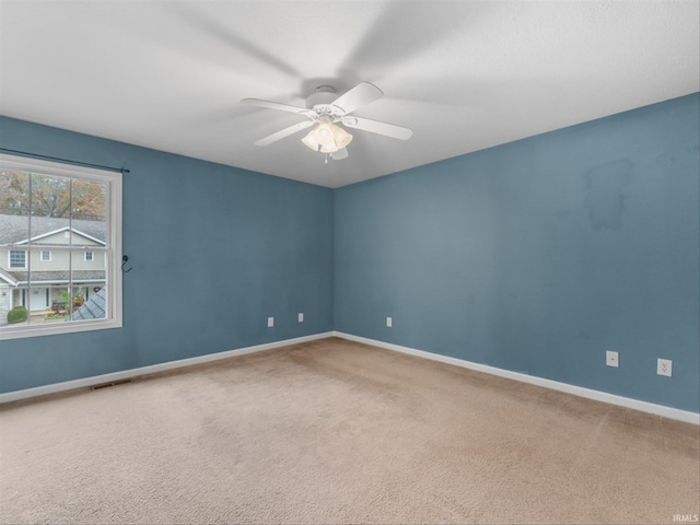 unfurnished room with ceiling fan and carpet flooring