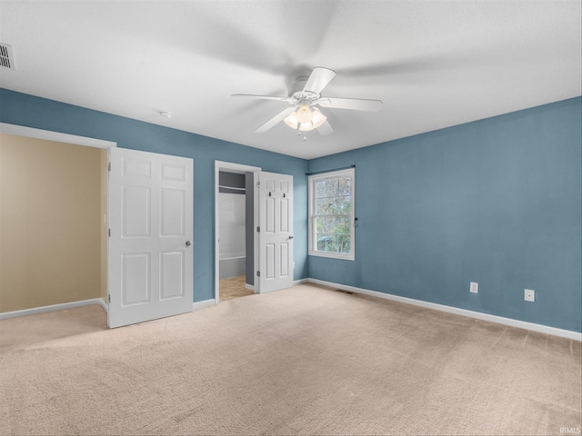 unfurnished bedroom featuring light colored carpet and ceiling fan