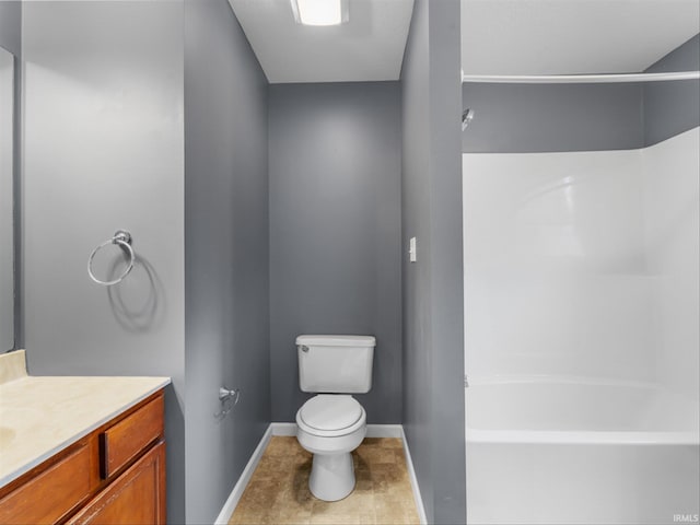 bathroom featuring toilet, vanity, and tile patterned flooring