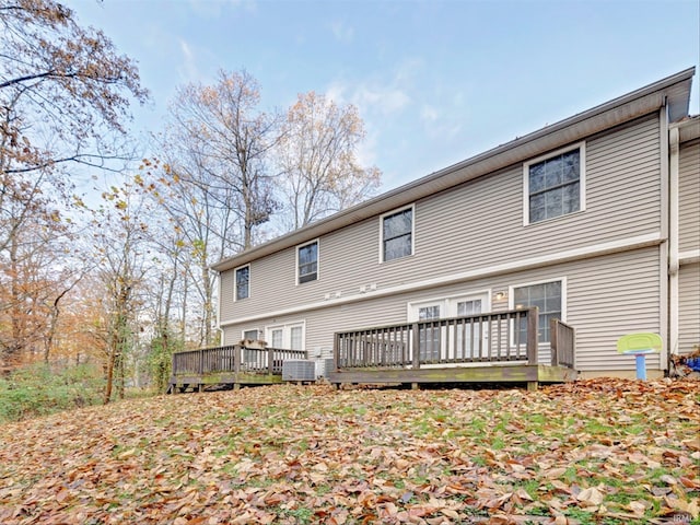 rear view of property with central AC unit and a deck