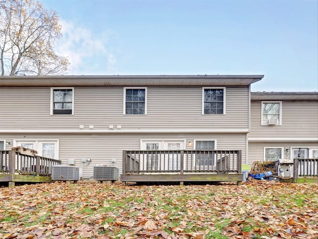 back of house with central AC unit and a wooden deck