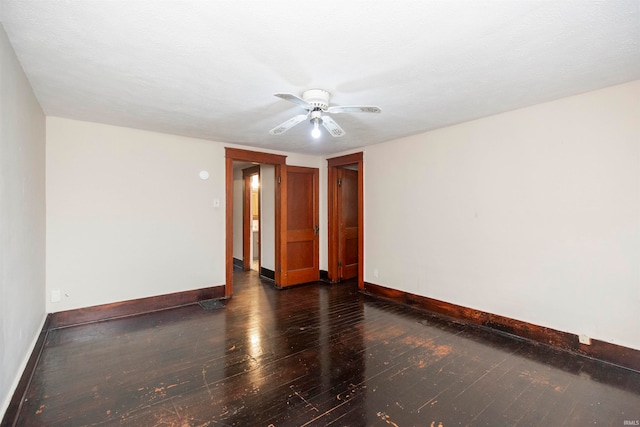 empty room with dark wood-type flooring, a textured ceiling, and ceiling fan