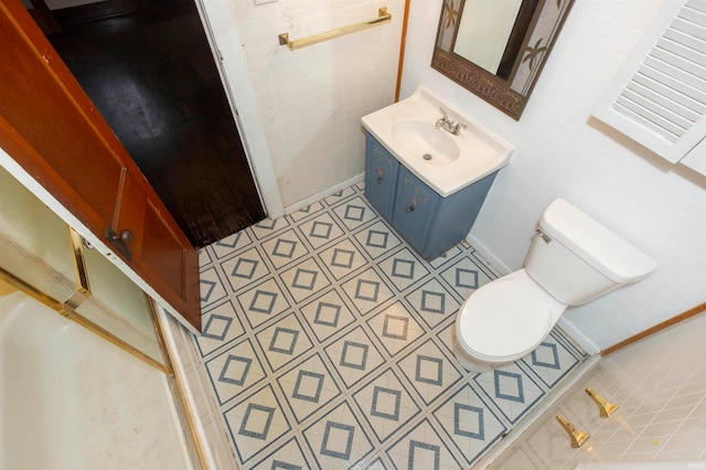 bathroom featuring vanity, tile patterned floors, and toilet