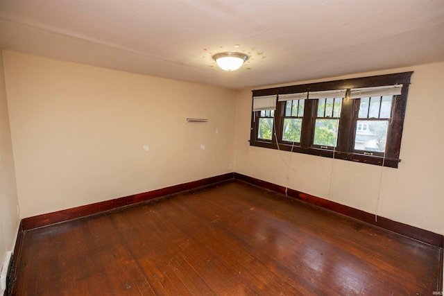 spare room featuring dark wood-type flooring