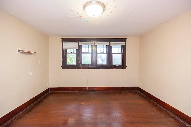 empty room featuring dark wood-type flooring