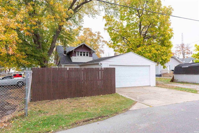 view of front of house featuring a garage and an outdoor structure