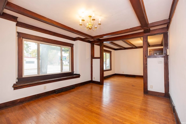 unfurnished room featuring beamed ceiling, a notable chandelier, and light hardwood / wood-style flooring