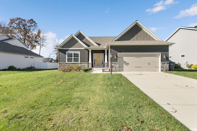 craftsman house featuring a garage and a front lawn