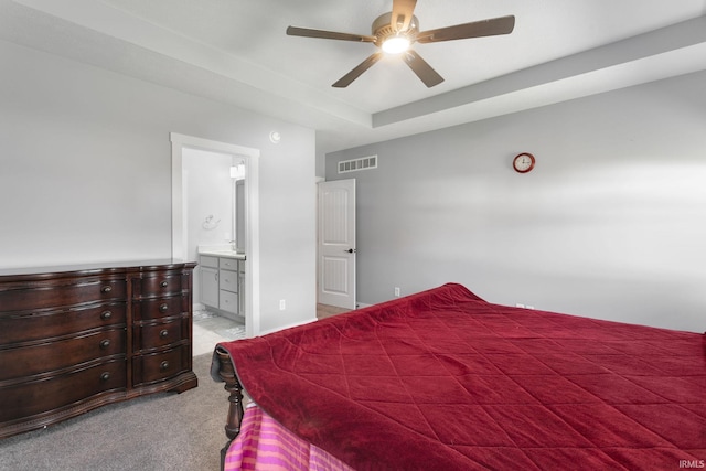 carpeted bedroom with ceiling fan and ensuite bath