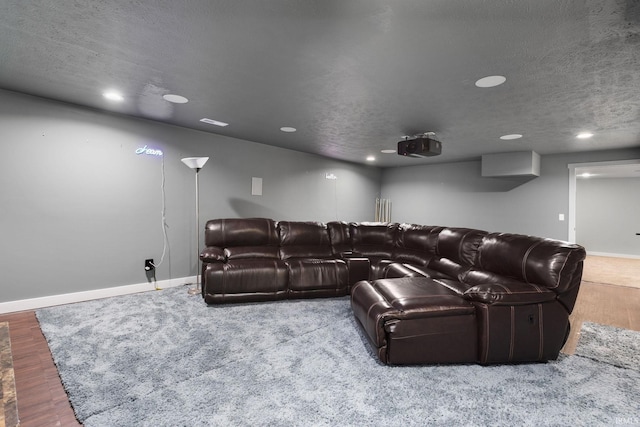 cinema with hardwood / wood-style flooring and a textured ceiling