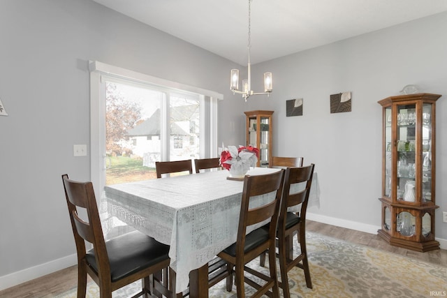 dining area featuring hardwood / wood-style floors and a notable chandelier