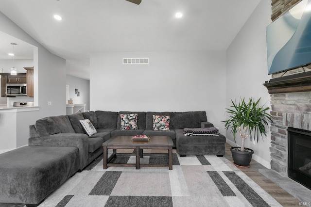 living room with light hardwood / wood-style floors and a fireplace