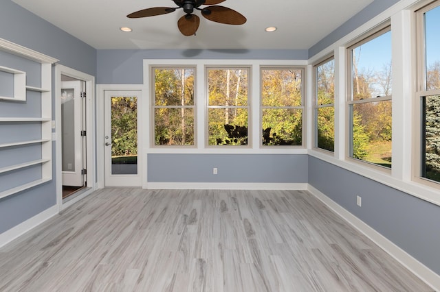 unfurnished sunroom with plenty of natural light and ceiling fan