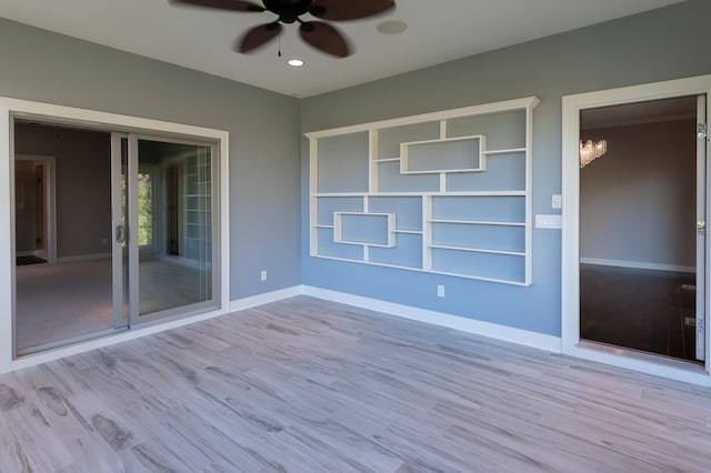 empty room featuring ceiling fan and light wood-type flooring