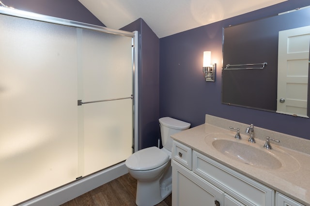 bathroom with vanity, hardwood / wood-style floors, vaulted ceiling, and a shower with shower door