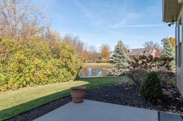 view of yard with a patio and a water view