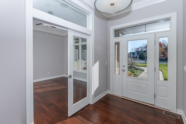 entryway with french doors, dark hardwood / wood-style floors, and crown molding