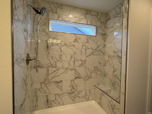 full bath with a tile shower