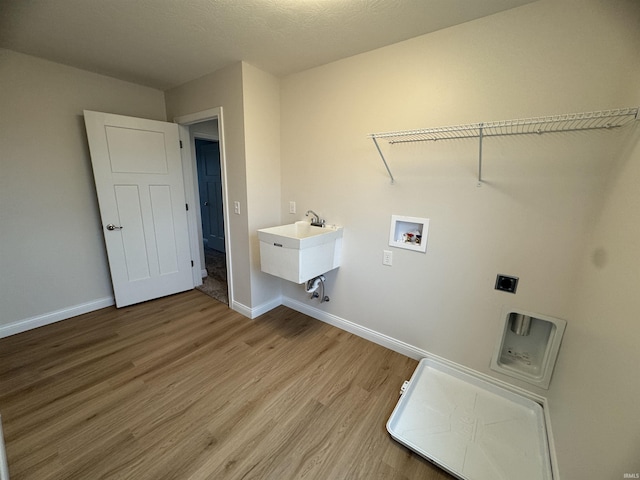 laundry room with light wood-style floors, baseboards, hookup for an electric dryer, hookup for a washing machine, and laundry area