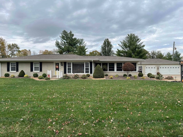 single story home with a garage and a front lawn