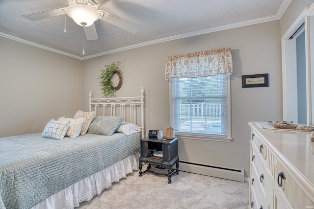 carpeted bedroom with a textured ceiling, crown molding, ceiling fan, and a baseboard heating unit