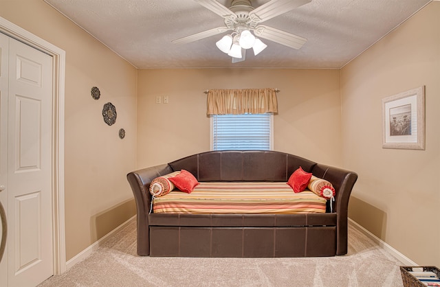 carpeted bedroom featuring a textured ceiling, a closet, and ceiling fan